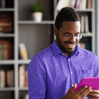 man at home looking at tablet