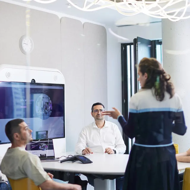 Image of team discussing in an meeting room