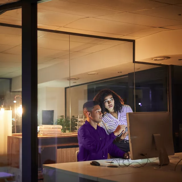 two people looking at computer