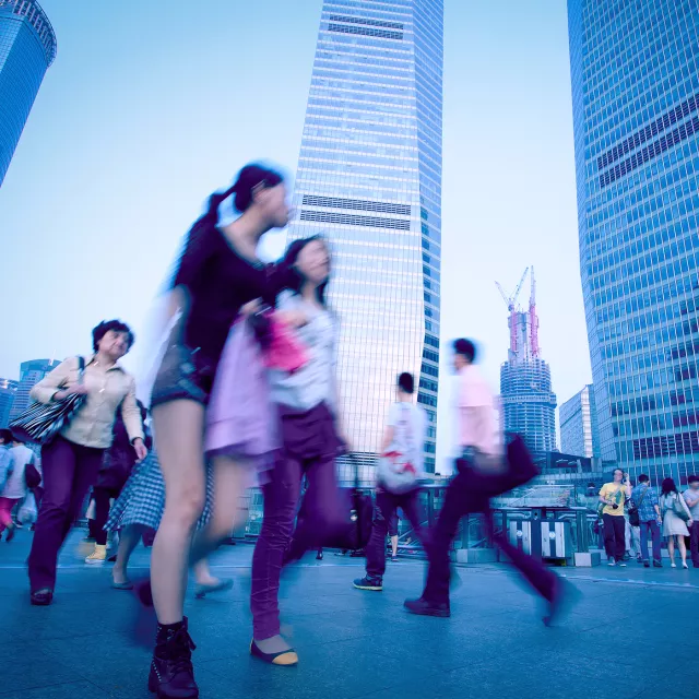 people rushing past buildings