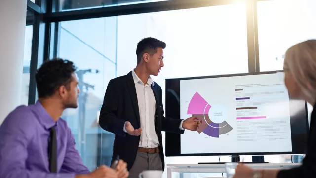 Man presenting on large screen