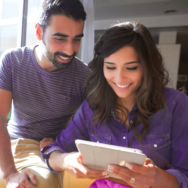 Image of man and woman looking at tablet