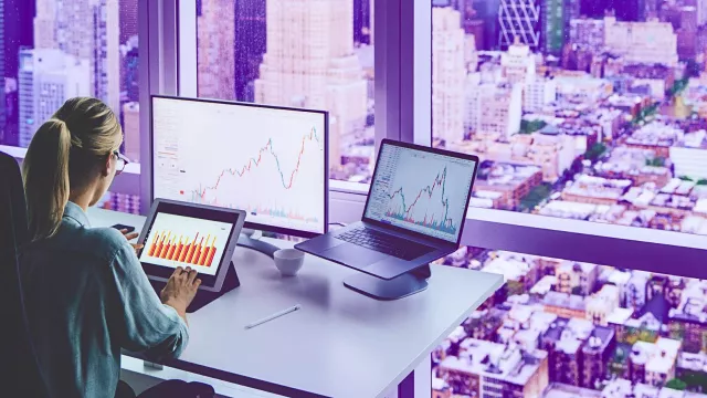 girl working on a financial report with a view of new york in the background