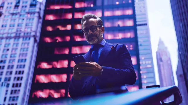 Image of man on phone outside a building