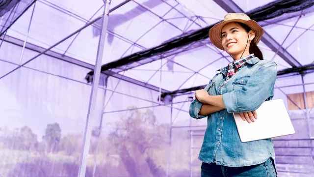 Image of woman inside greenhouse