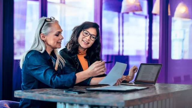 Image of women discussing in an office