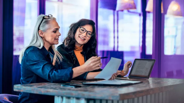 Image of two women discussing report