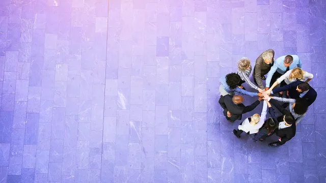 Image of people standing in a circle