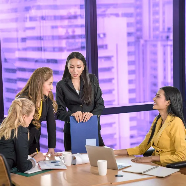 Image of four women collaborating together