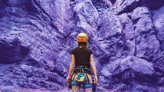 Image of climber woman looking up to the mountain