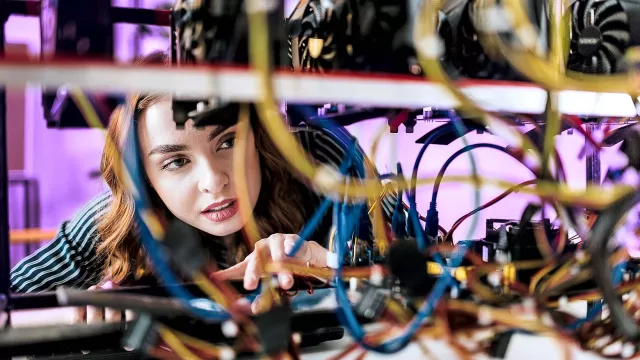 Image of woman checking server cable infrastructure