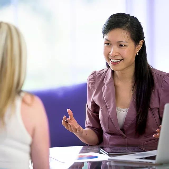 Image of woman talking with clients