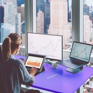 Image of woman working on graphs in an office