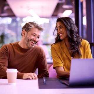 Two persons talking at the office