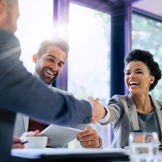 Image of a person smiling and two person handshaking