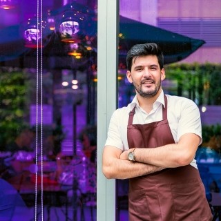 Image of business owner standing outside a building