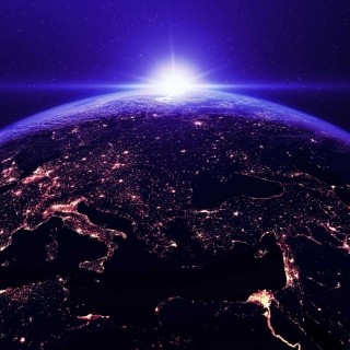 Earth from space with illuminated cities and a purple sky