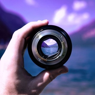 Image of a hand holding a camera lens