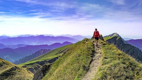 Image of person hiking on top of mountains