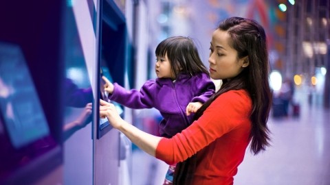 Image of woman and child using an ATM